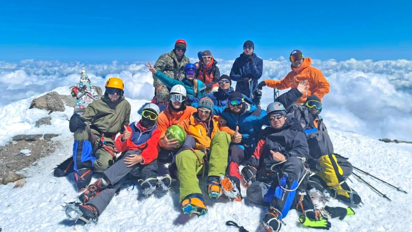 A victorious team celebrates a top Elbrus, above the clouds - B4Experience.