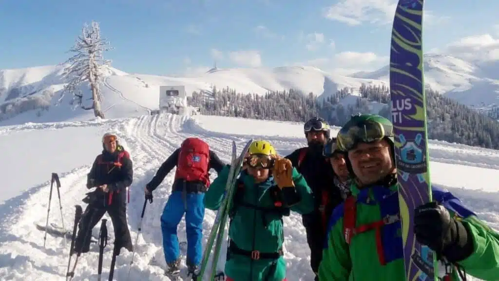 Smiling skiers ready for deep powder runs with B4Experience.