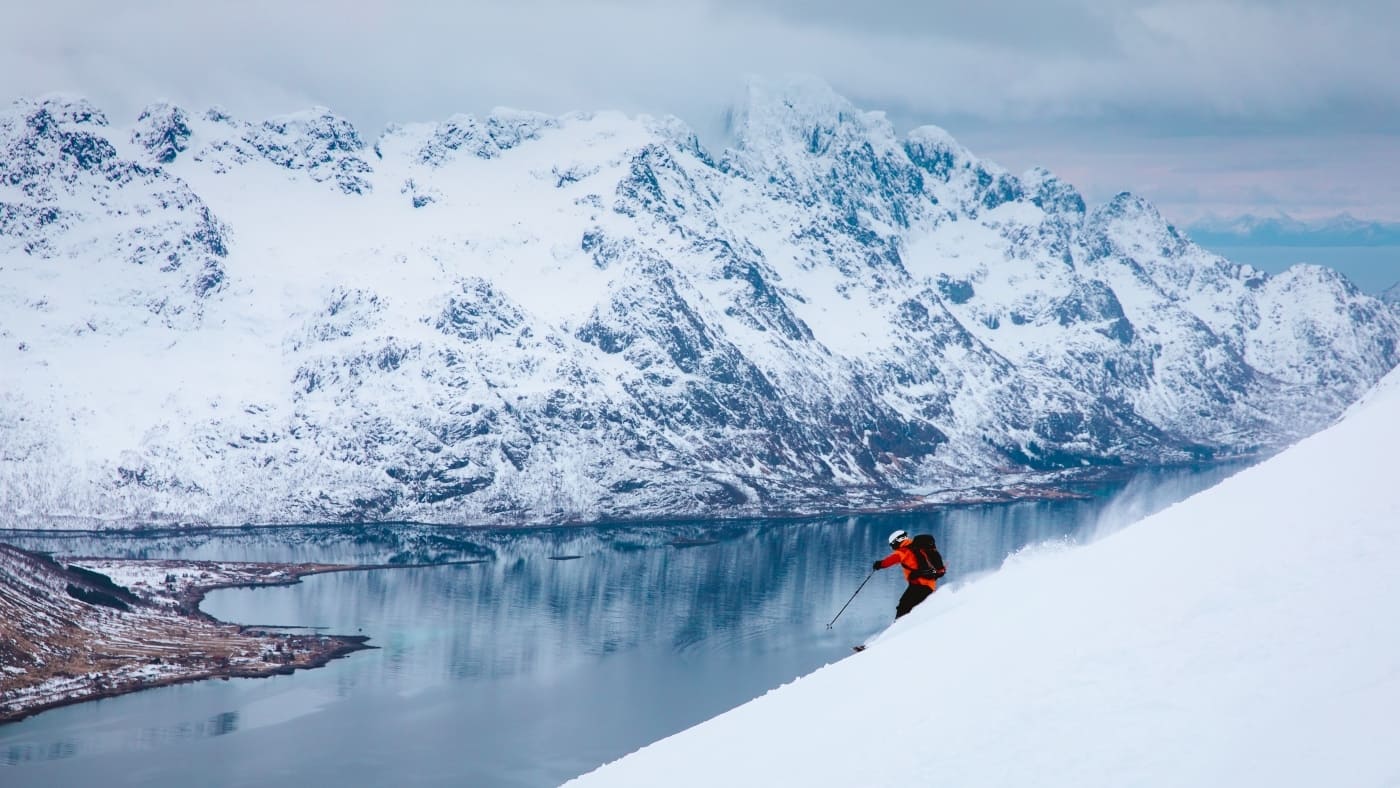 Skier enjoying a descent in a Norwegian fjord