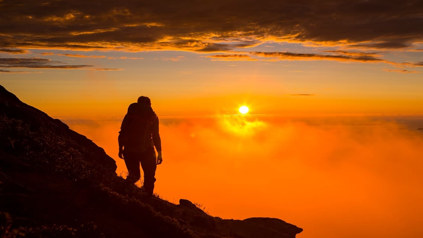 man on the mountain with the midnight sun