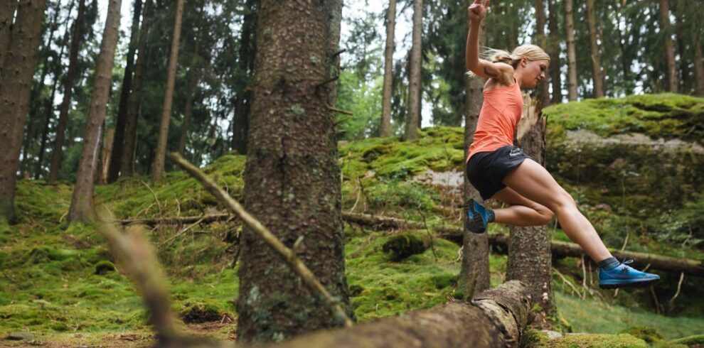 Woman running through the forest