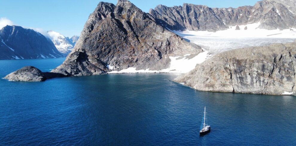 Landscape of sailboat in the sea and snowy mountains