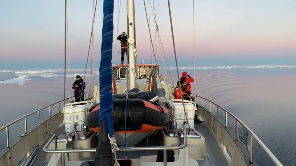 Crew sailing on sailboat with beautiful lights