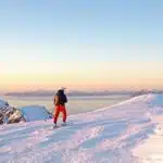 Skiers on top of a mountain in Lofoten