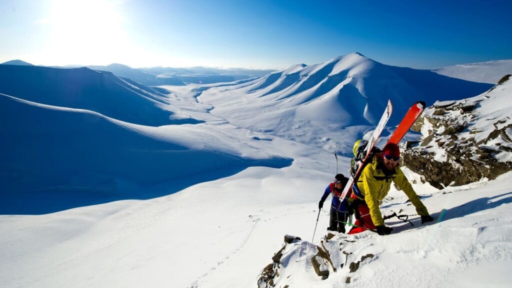 Skiers reaching the summit. Amazing views of Svalbard