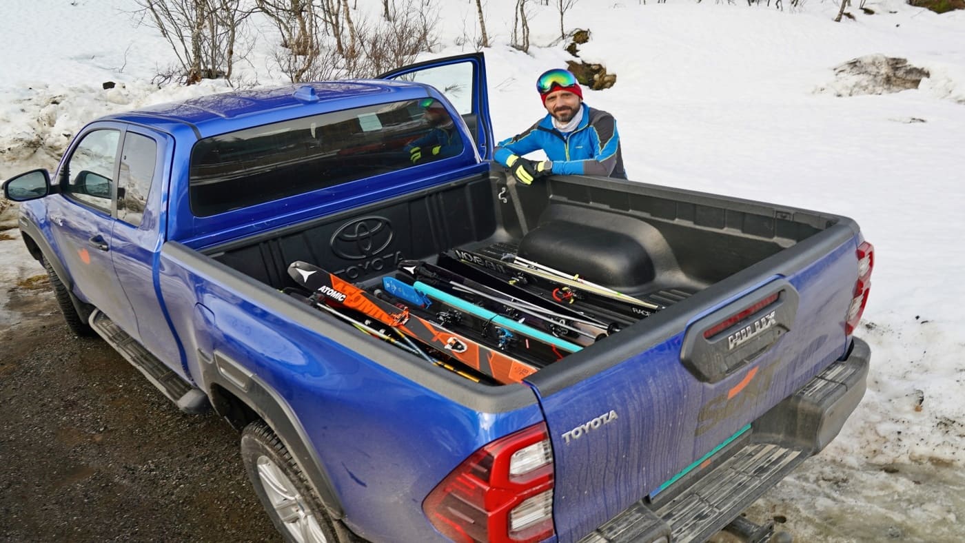 Skier looks on as he packs all his ski gear into the truck