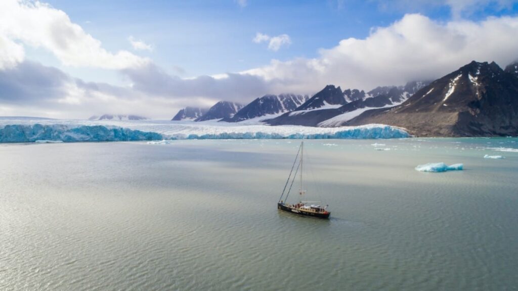 Sailboat approaching the polar ice shelf at the North Pole