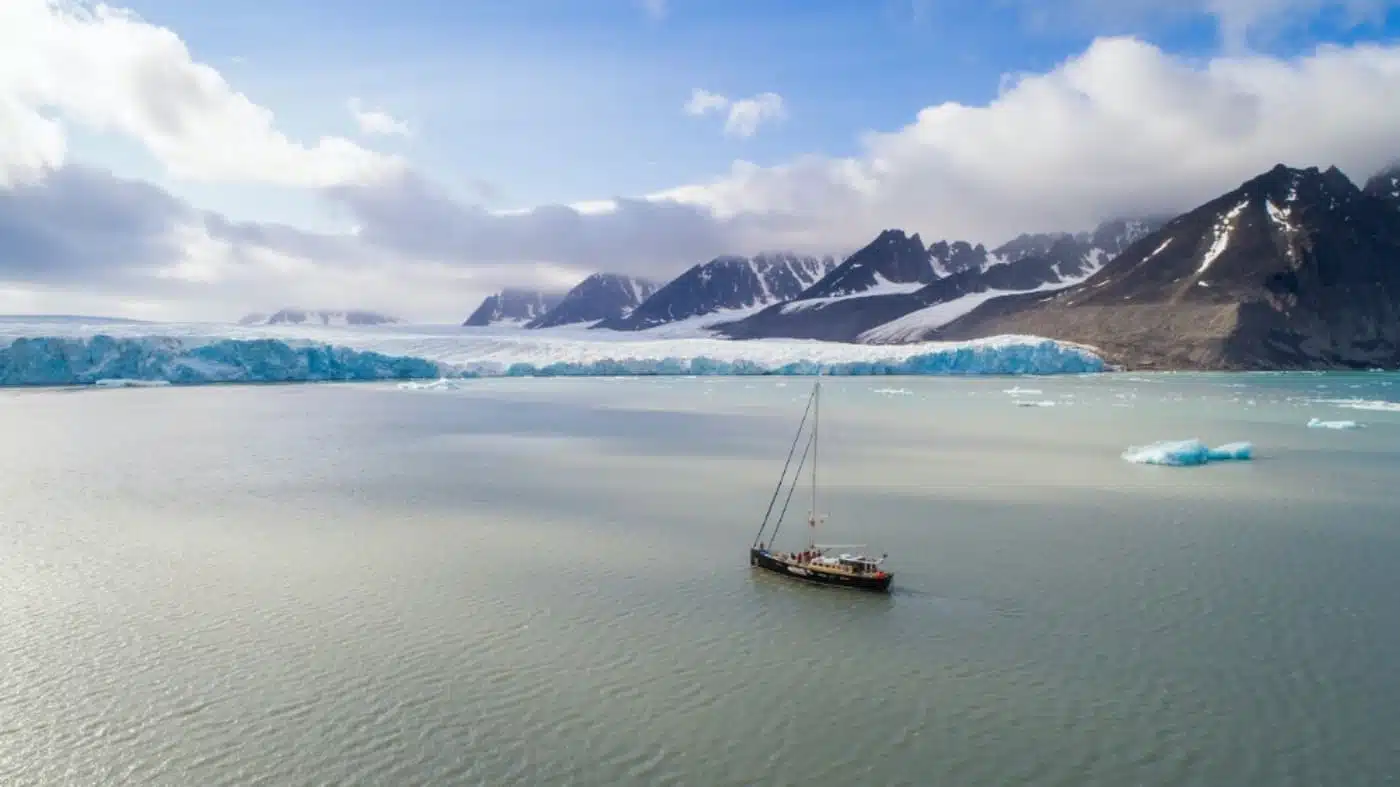 Sailboat approaching the polar ice shelf at the North Pole