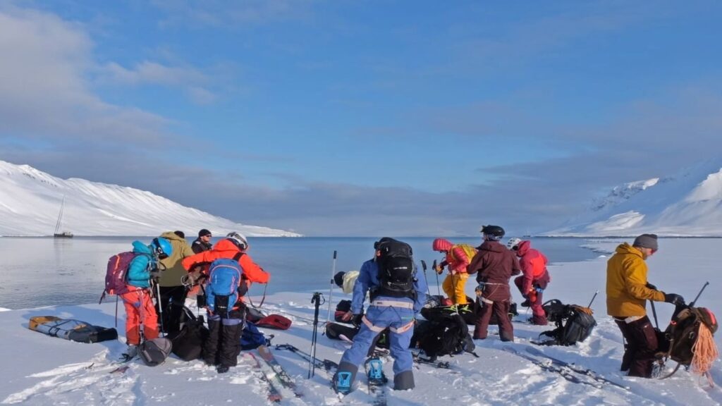 Group of skiers on the beach preparing to start skiing