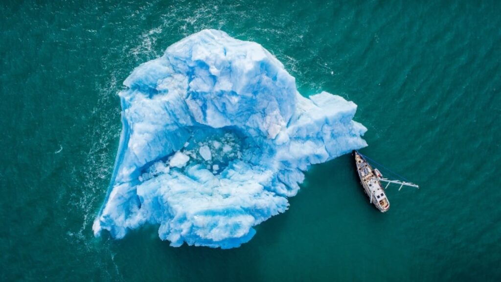 Sailboat moored to an iceberg, Svalbard