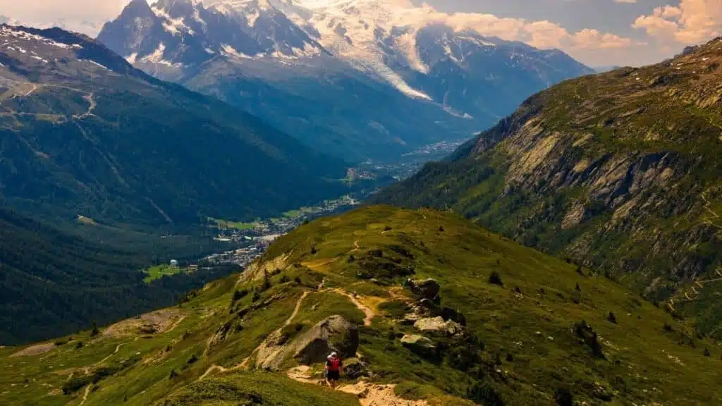 Trail runner on a scenic alpine ridge with mountain views.