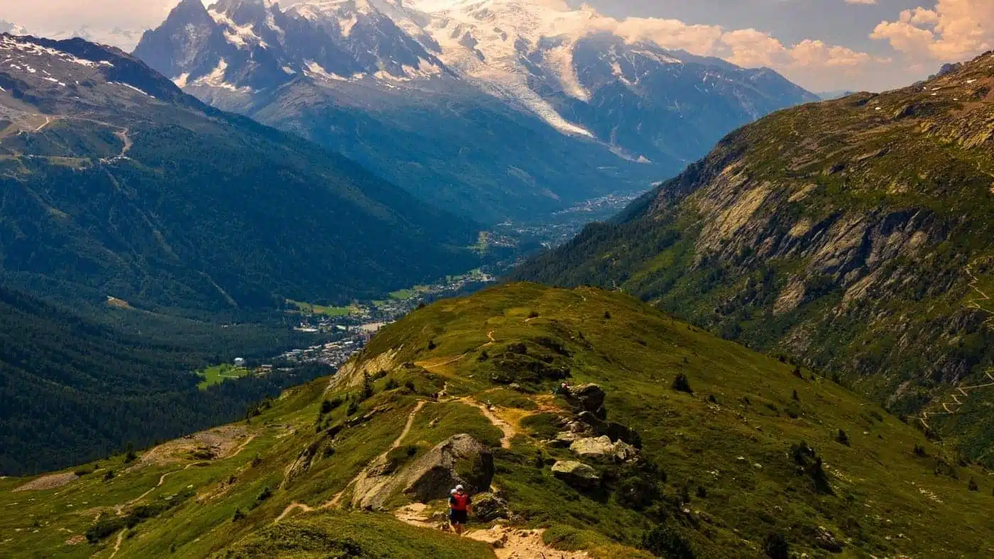 Trail runner on a scenic alpine ridge with mountain views.