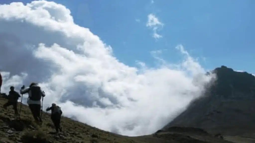 Hikers trekking through clouds on Aragats mountain with B4Experience