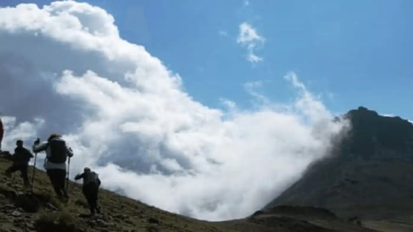 Hikers trekking through clouds on Aragats mountain with B4Experience