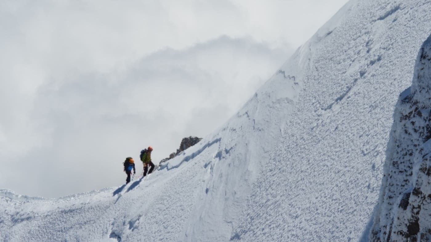 Climbing the icy ridge towards Mont Blanc's summit with B4Experience