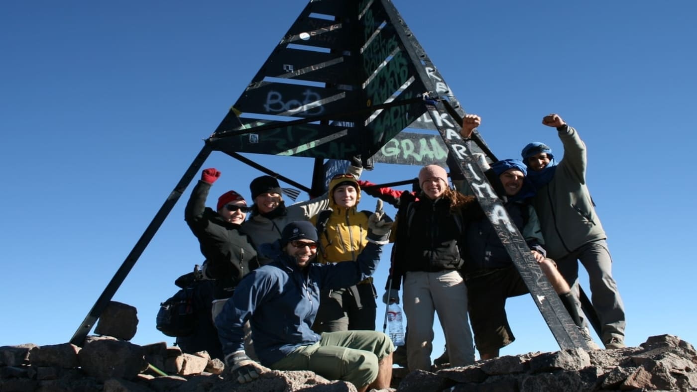 Group of climbers celebrating at the summit of Mount Toubkal with B4Experience