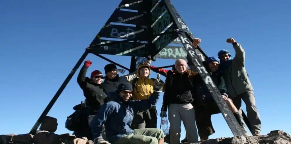 Group of climbers celebrating at the summit of Mount Toubkal with B4Experience
