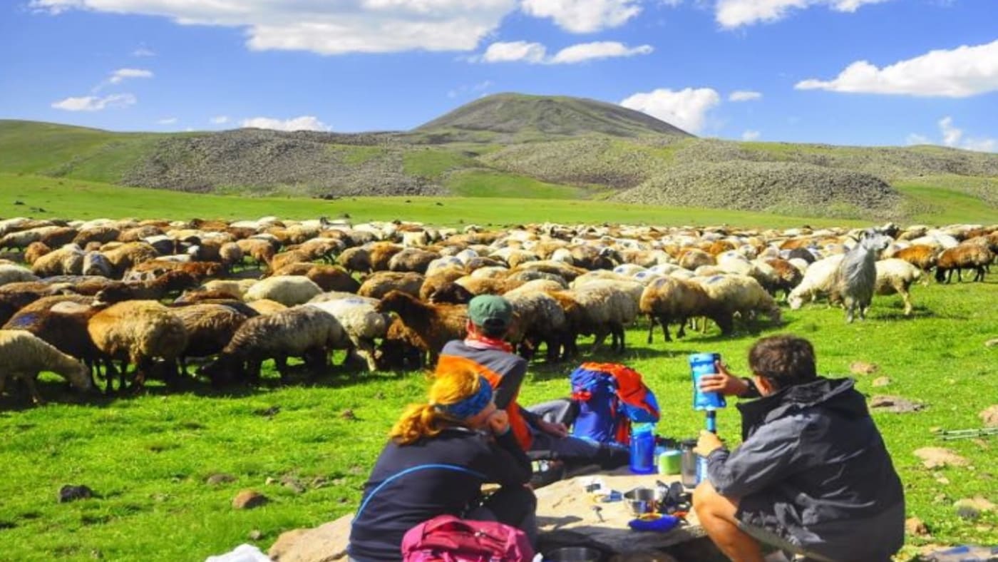 Hiking Caucasus picnic in a green pastures surrounded with B4Experience