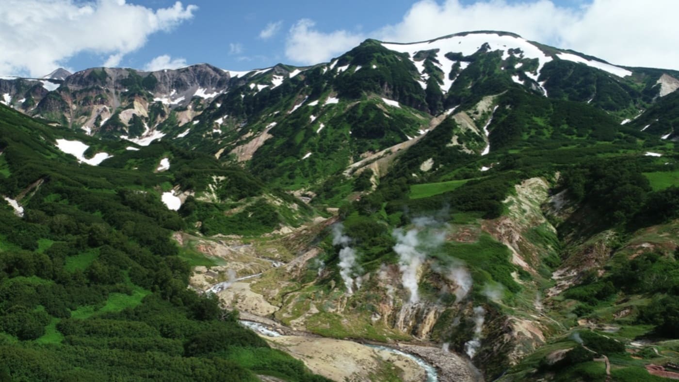 Lush green valleys with geothermal steam vents in Kamchatka with B4Experience