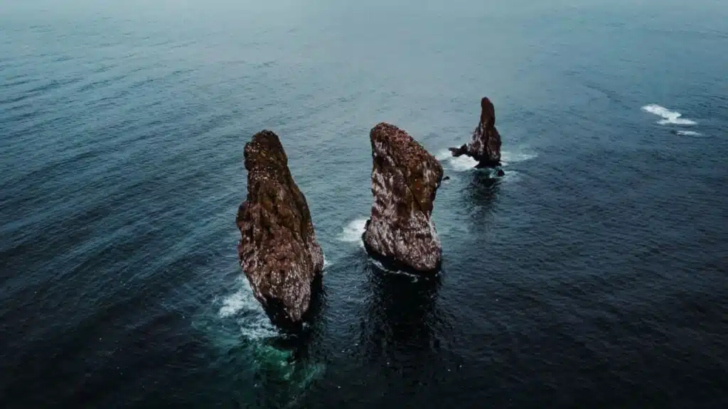 Jagged sea stacks rising from the Pacific off Kamchatka's coast with B4Experience