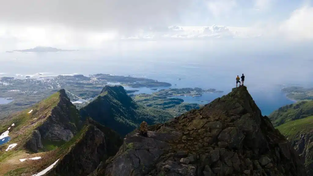 Hikers enjoying a breathtaking view on a Lofoten trek with B4Experience.