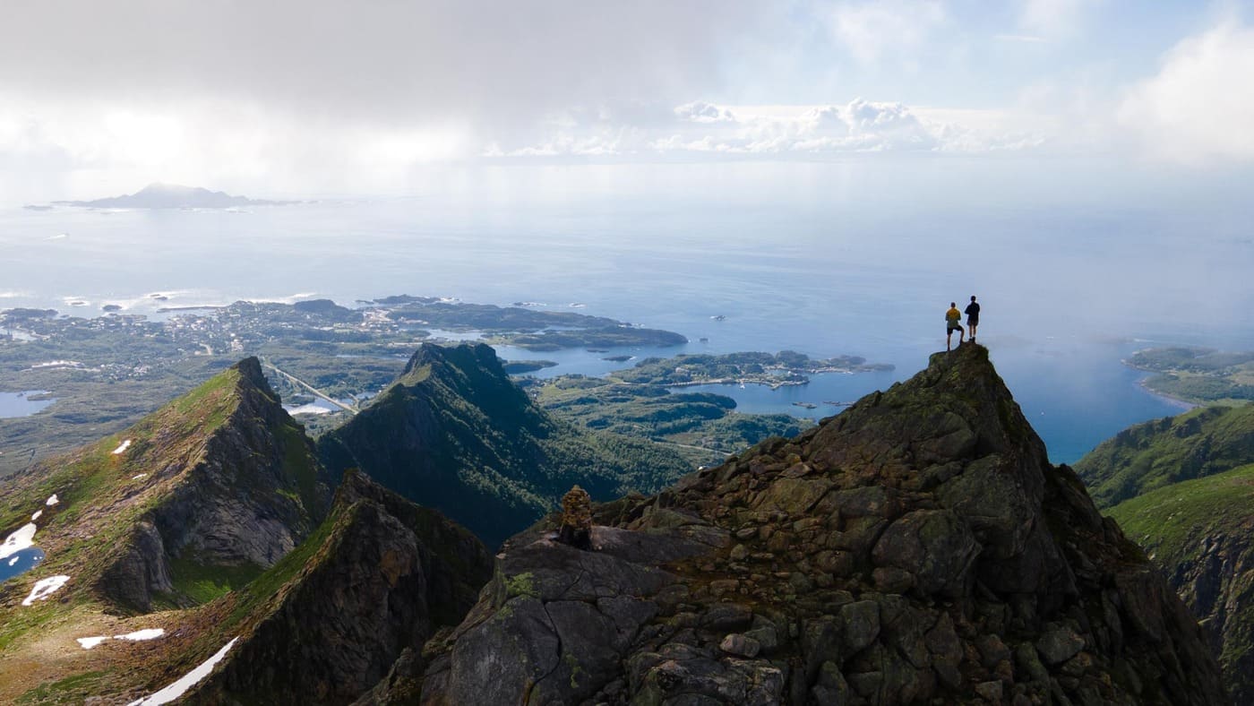 Hikers enjoying a breathtaking view on a Lofoten trek with B4Experience.