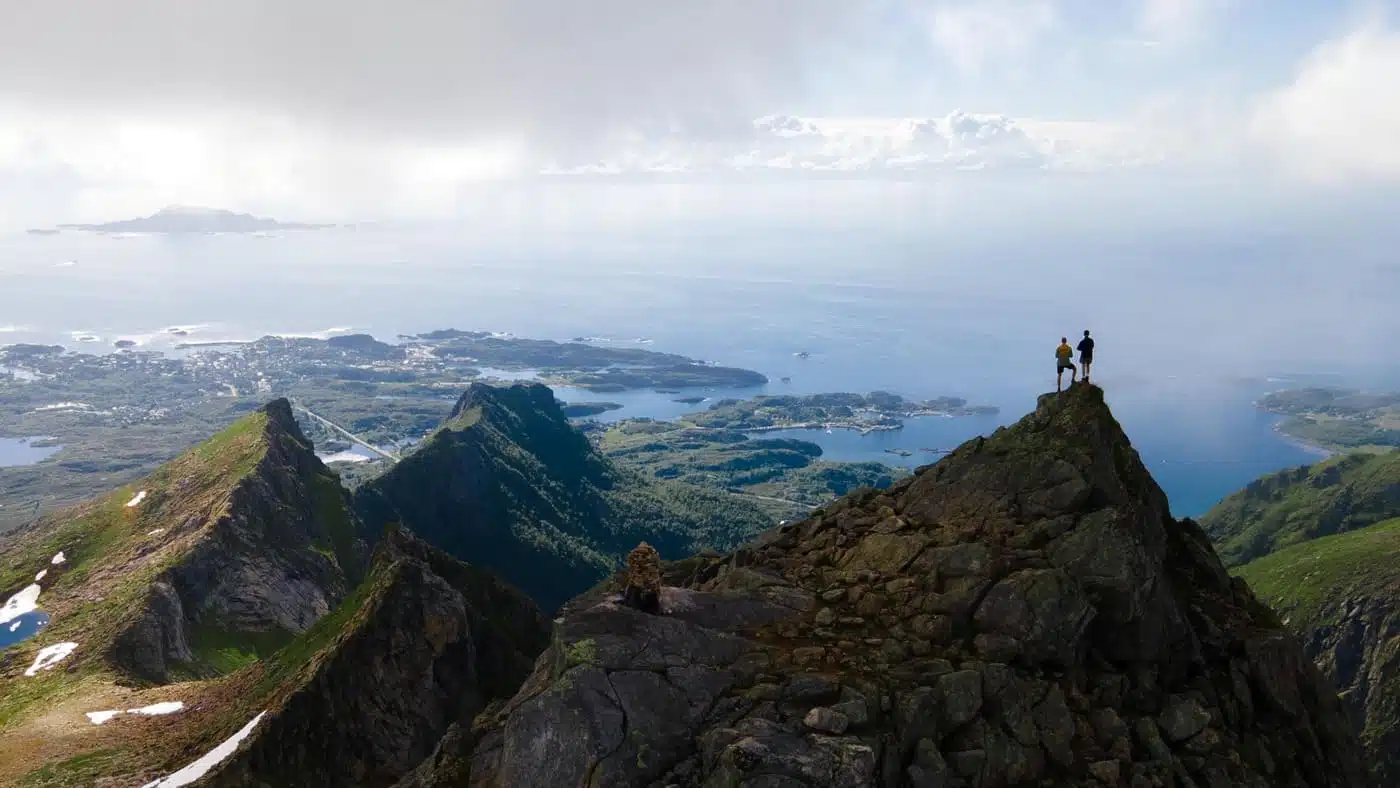 Hikers enjoying a breathtaking view on a Lofoten trek with B4Experience.