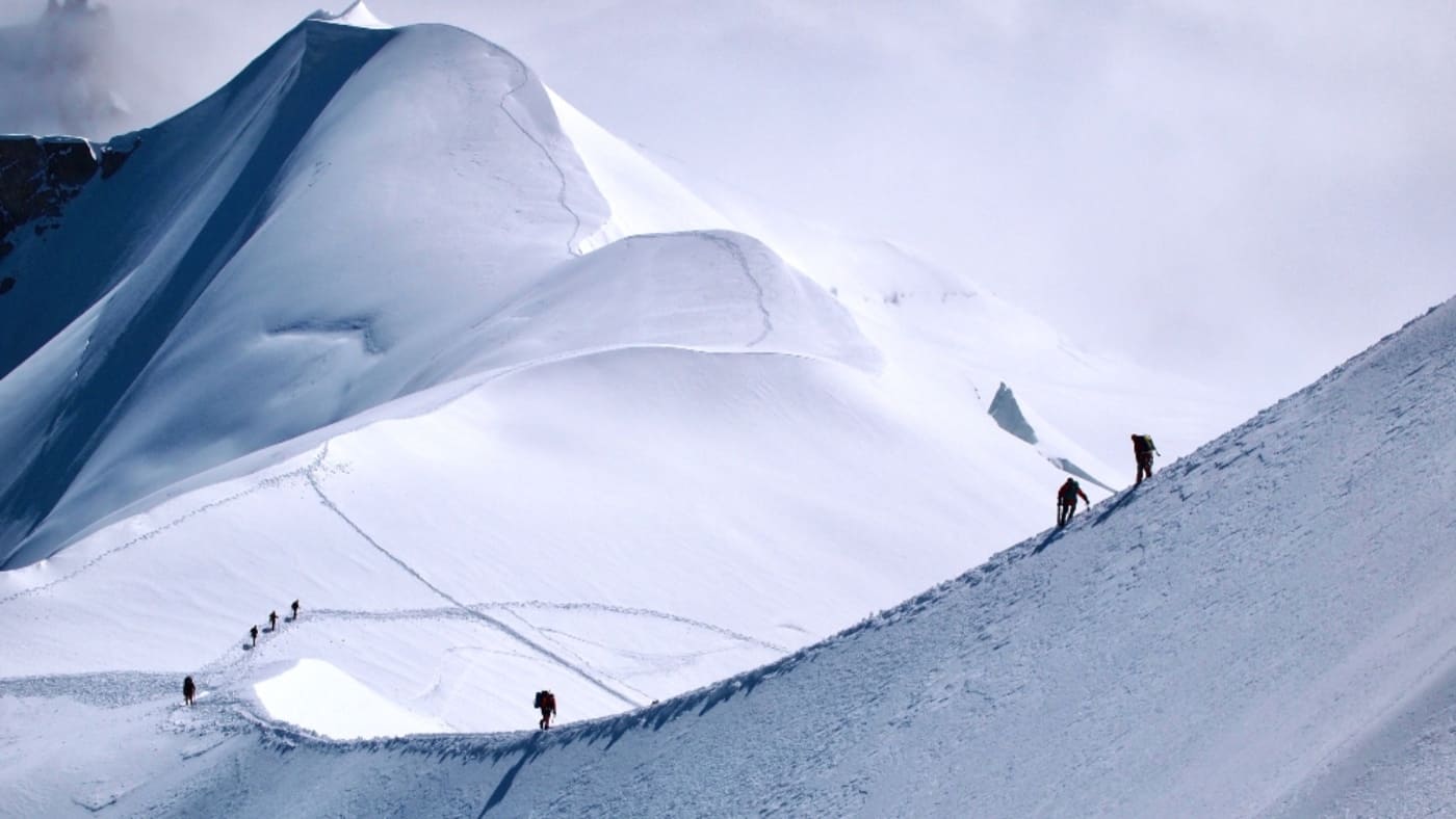 Climbers ascend the snowy ridge of Mont Blanc with B4Experience