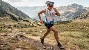 Trail runner sprinting through a mountainous landscape, Nuria Picas- B4Experience.