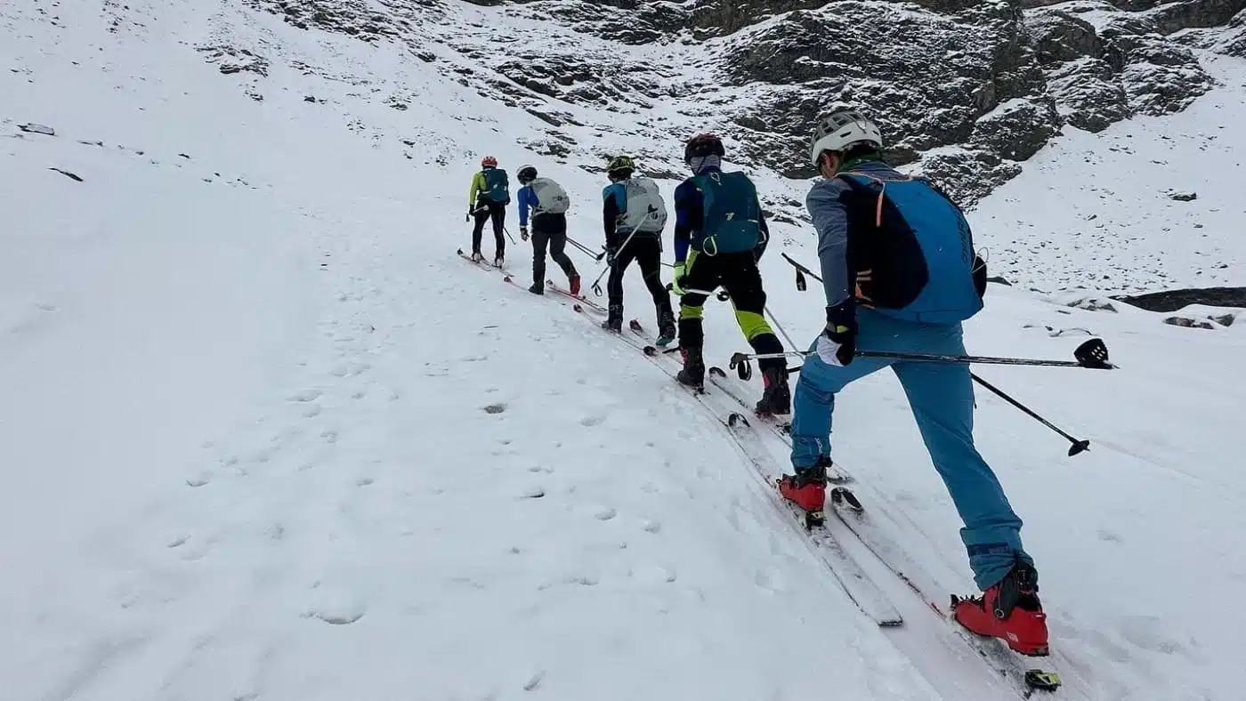 Group of skiers ascending a snow mountain with B4Experience