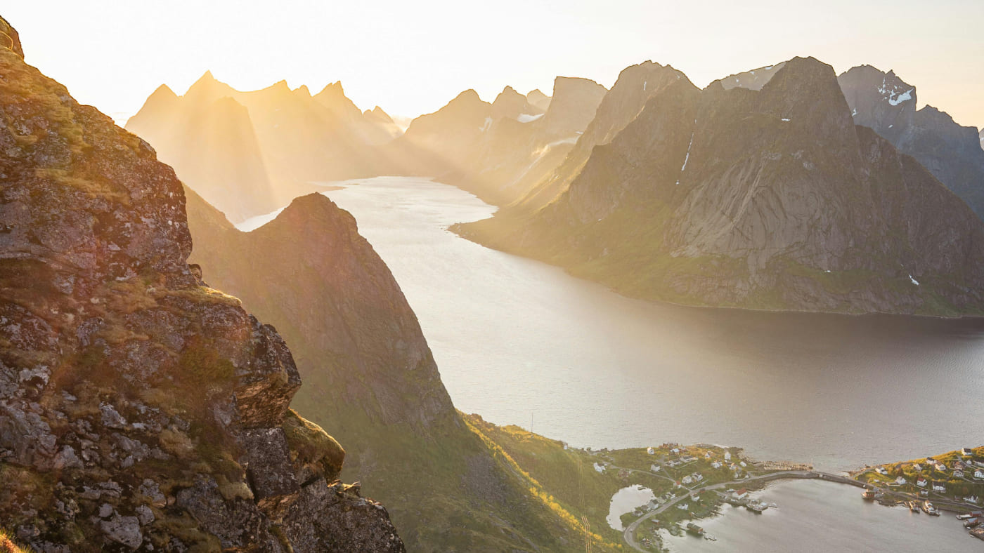 Lofoten fjord at sunset with sharp peaks.