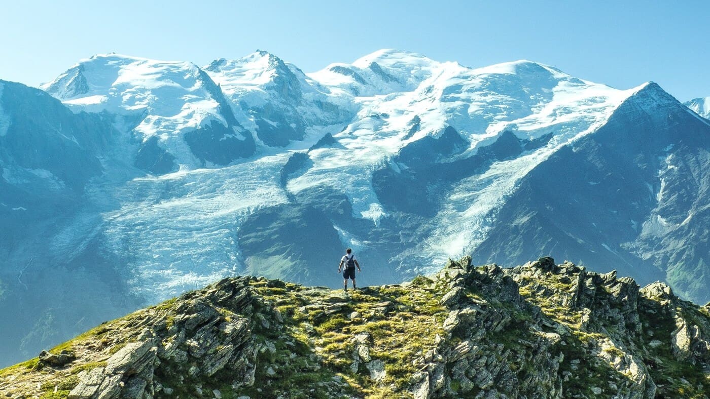 Trekker standing on a ridge with the stunning Chamonix Alps with B4Experience