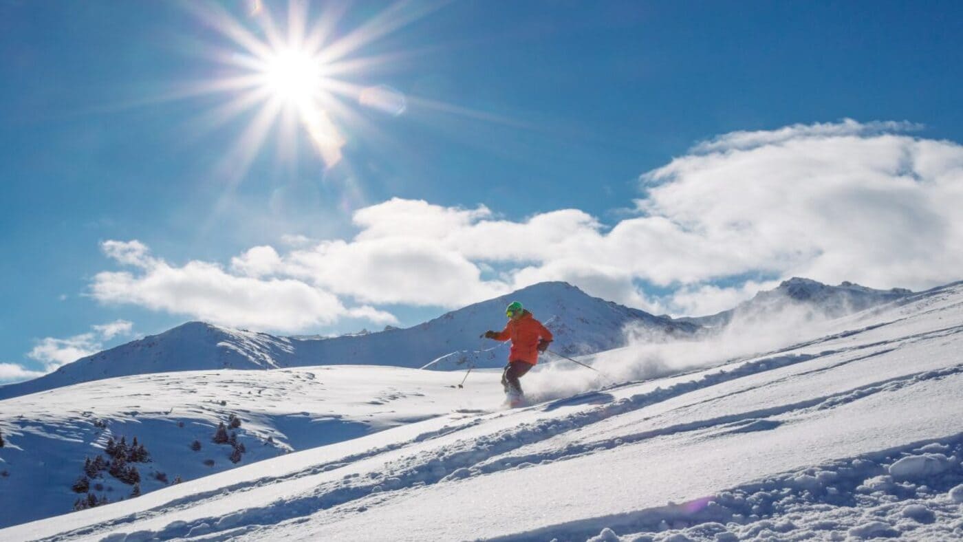 Pristine Kyrgyzstan powder under a bright winter sun, perfect for freeride skiing with B4Experience