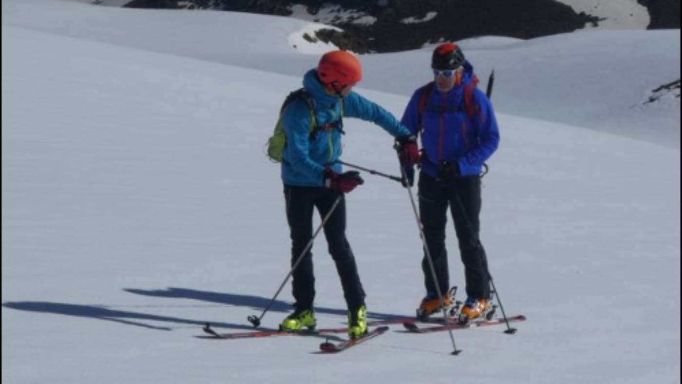 Two skiers on a snowy slope practicing with B4Experience