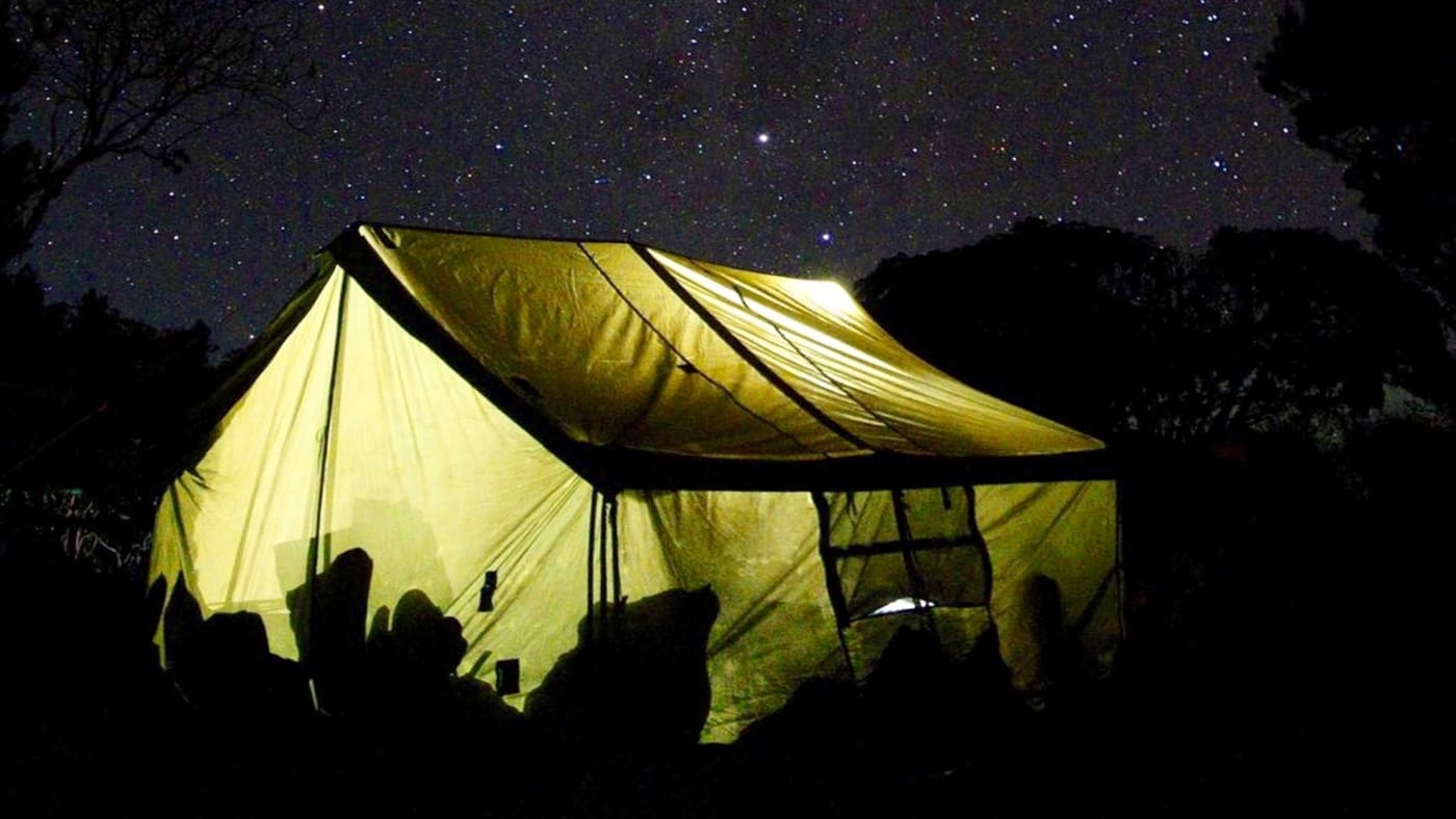 Glowing tent under Kilimanjaro's starry sky with B4Experience