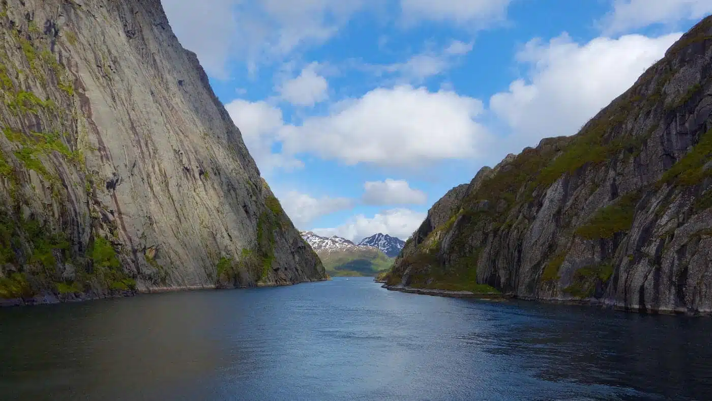 Narrow fjord with steep cliffs and calm water.