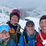 Smiling group of skiers in snowy mountains - B4Experience
