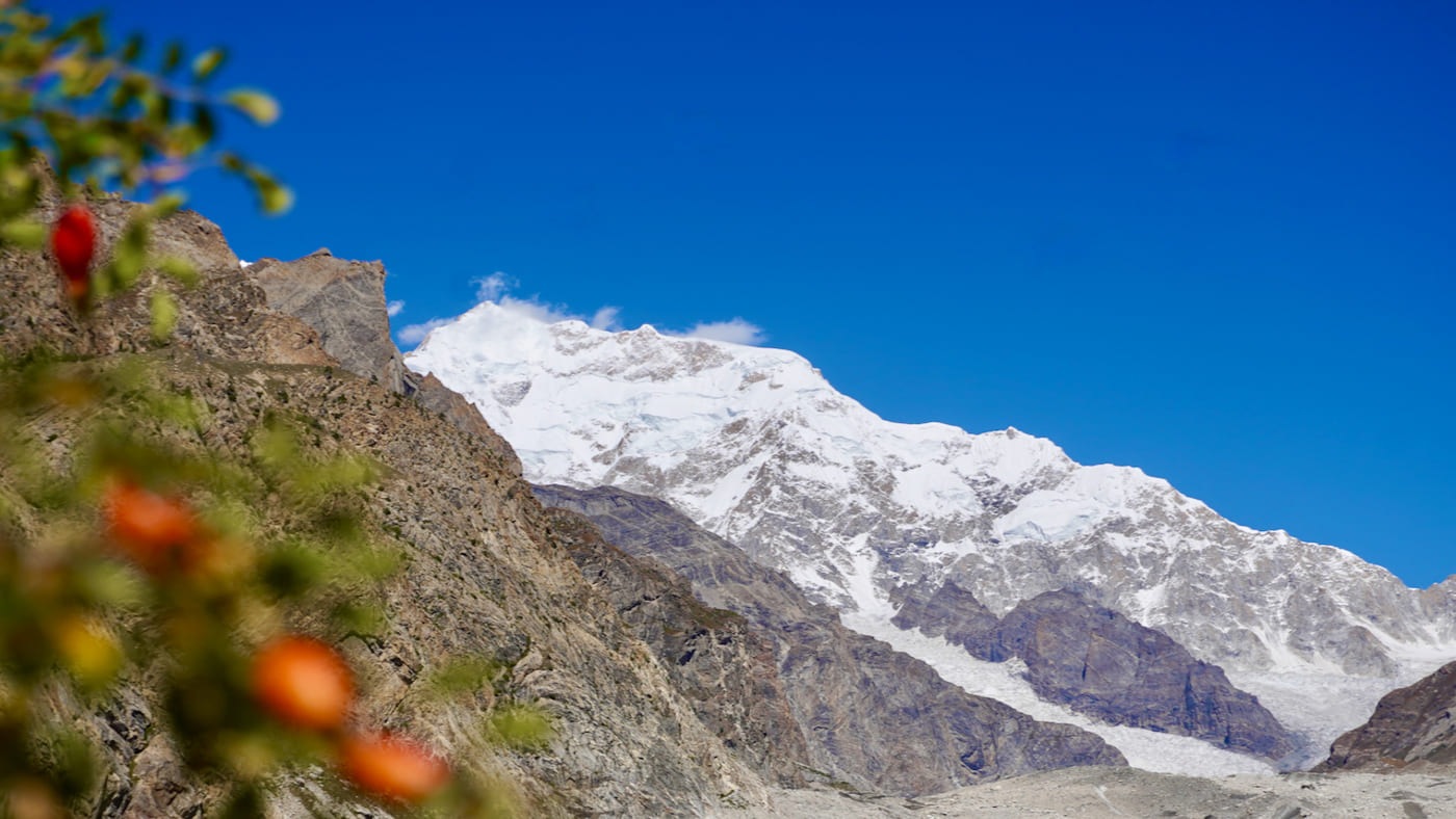 Snow-covered Laila Peak rises majestically against the clear blue sky - B4Experience