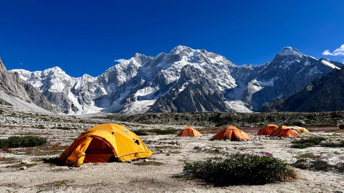 Campsite in Pakistan with bright tents set against the breathtaking mountains - B4Experience