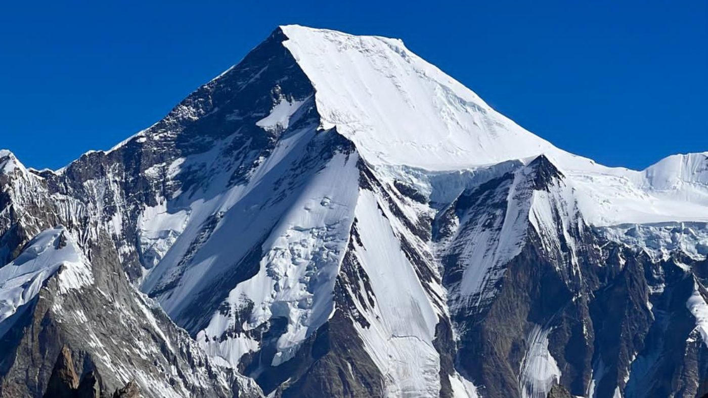 Majestic snow-covered peaks near Karakoram alpine School, standing tall under a clear blue sky - B4Experience