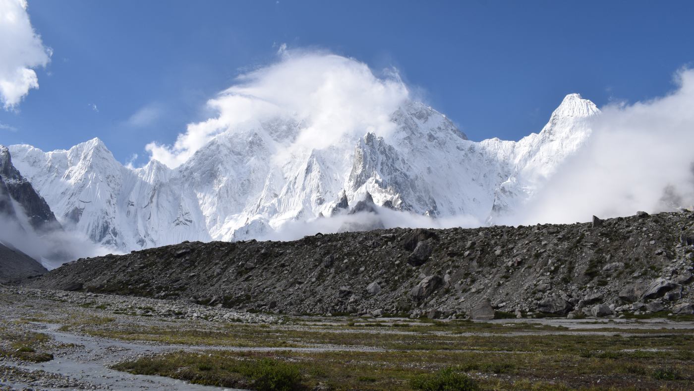 Majestic view of Pc Ismail Hushevi with clouds rolling over the peaks - B4Experience