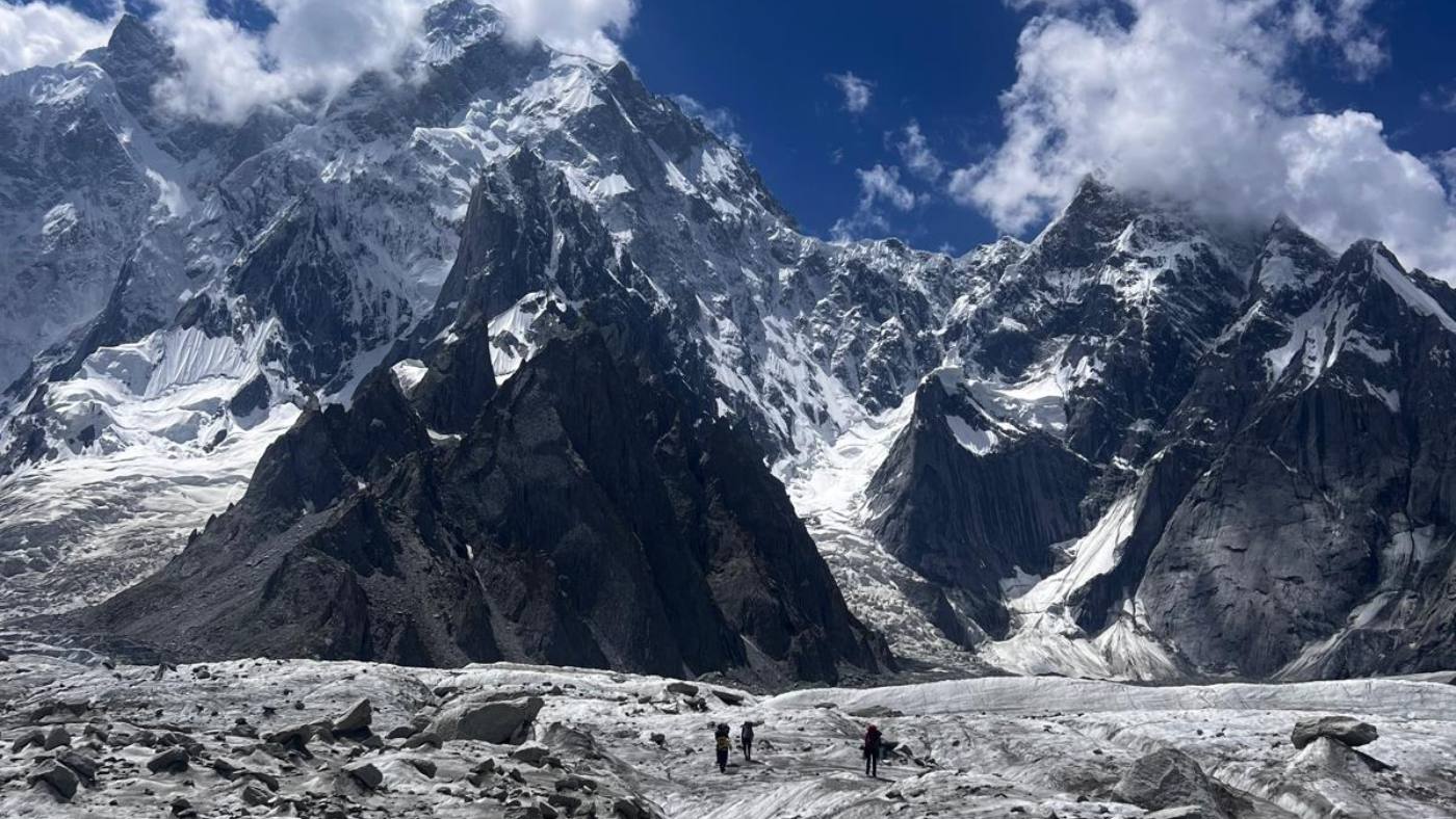 Towering peaks of the Karakoram Alpine School with trekkers crossing glaciers - B4Experience