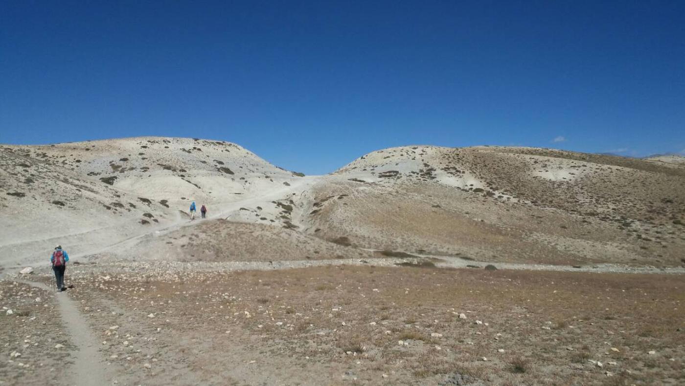 Trekkers walking through Mustang's arid with B4Experience