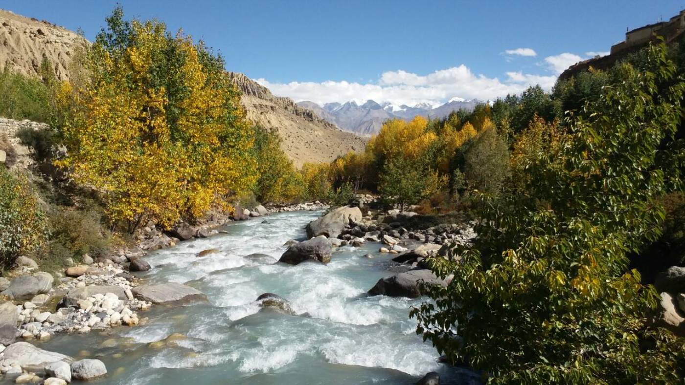 Turquoise river amid autumn hues in Mustang, Nepal - B4Experience