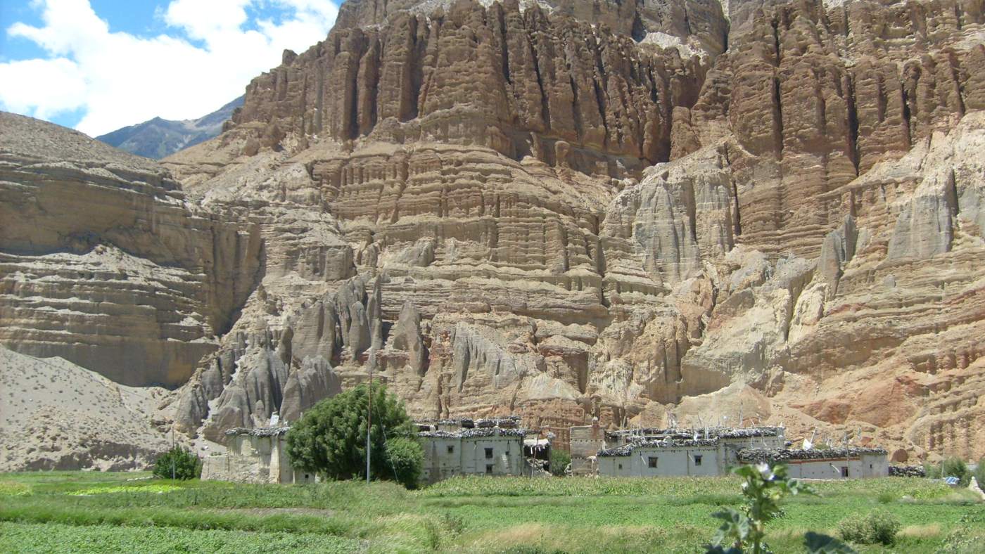 Ancient cliffs and traditional homes in Mustang, Nepal with B4Experience