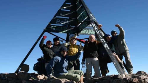 Group of climbers celebrating at the summit of Mount Toubkal with B4Experience