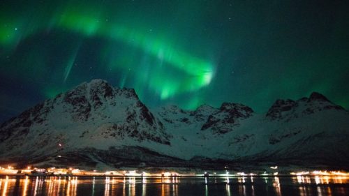 Snowy and maritime landscape with northern lights