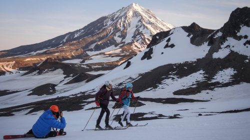 Photographer capturing skiers on snowy mountain landscape with B4Experience